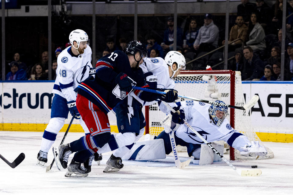 Tampa Bay Lightning goaltender Andrei Vasilevskiy (88) reaches for the puck after New York Rangers left wing Alexis Lafreniere (13) during the second period of an NHL hockey game on Wednesday, Feb. 7, 2024 in New York. (AP Photo/Peter K. Afriyie)
