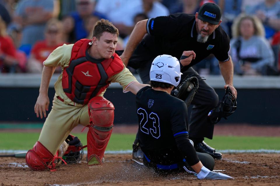 Trinity Christian's Jordan Martinez (23) slides safely into home plate to score a run on Thursday against Bishop Snyder. Martinez tied for the Northeast Florida lead in home runs.