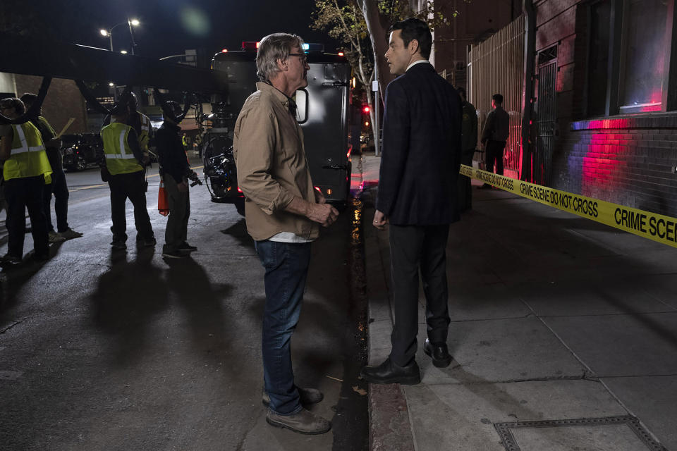 This image released by Warner Bros. Pictures shows director/writer/producer John Lee Hancock, center, and Rami Malek on the set of "The Little Things." (Nicola Goode/Warner Bros. Pictures via AP)