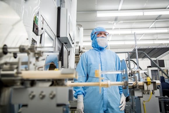 Finisar employee wearing a blue clean suit in a chip manufacturing plant