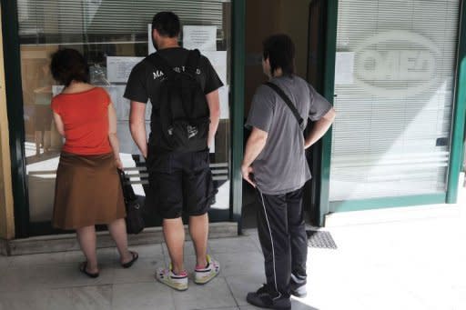 Job seekers looks at job offers in May 2012 outside an state employment office in Athens. As Greece struggles to get out of its financial crisis through spending cuts and economic reforms, the European Commission has promised to launch an action plan to boost youth employment by the end of this year