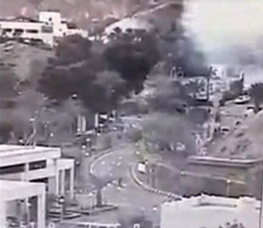 An image made from a video provided by the Israeli Airports Authority shows smoke, white area at upper right, from the bombing of the bus carrying South Korean sightseers near the tip of the Red Sea's Gulf of Aqaba Sunday, Feb. 16, 2014. At least three South Korean tourists were killed and 12 seriously wounded, according to Egyptian security officials. (AP Photo/Israeli Airports Authority)