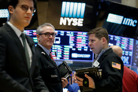 FILE PHOTO: Traders work on the floor of the New York Stock Exchange, (NYSE) in New York, U.S., February 26, 2018. REUTERS/Brendan McDermid