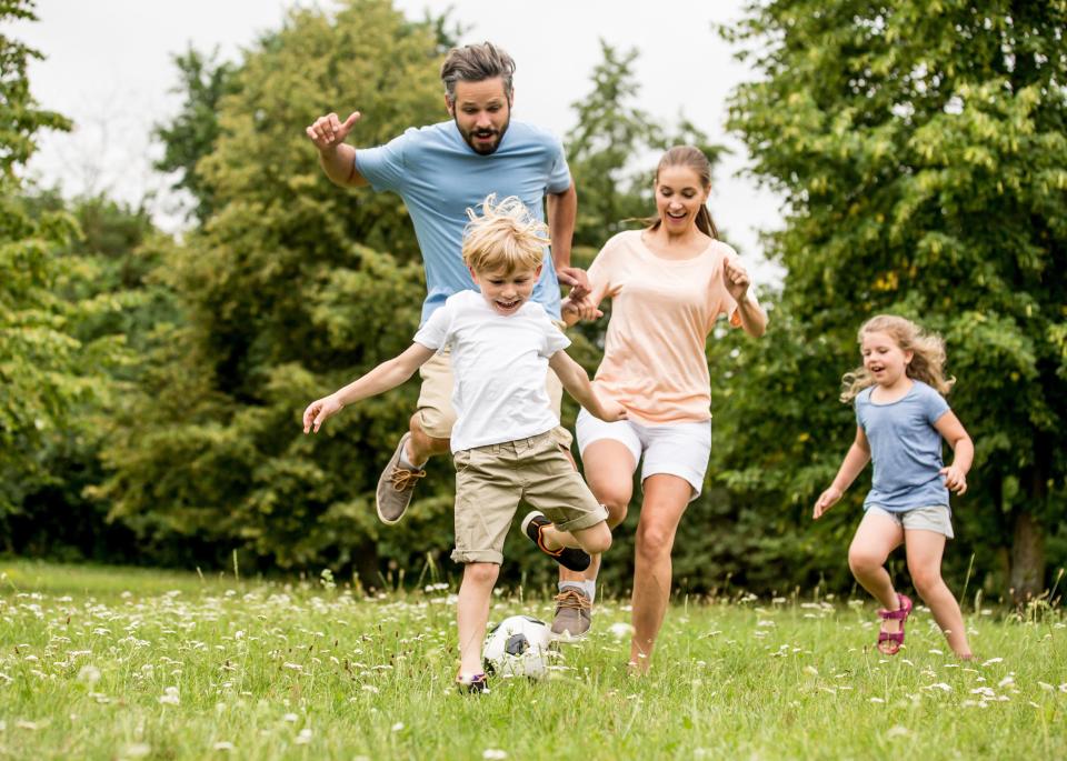 A family playing soccer together.