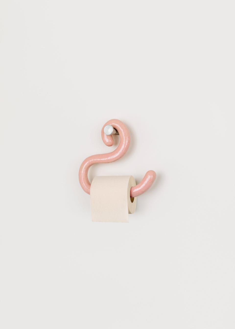 There are a variety of colorful ceramic holders on display by BNAG. This one is called Toilet Flamingo.