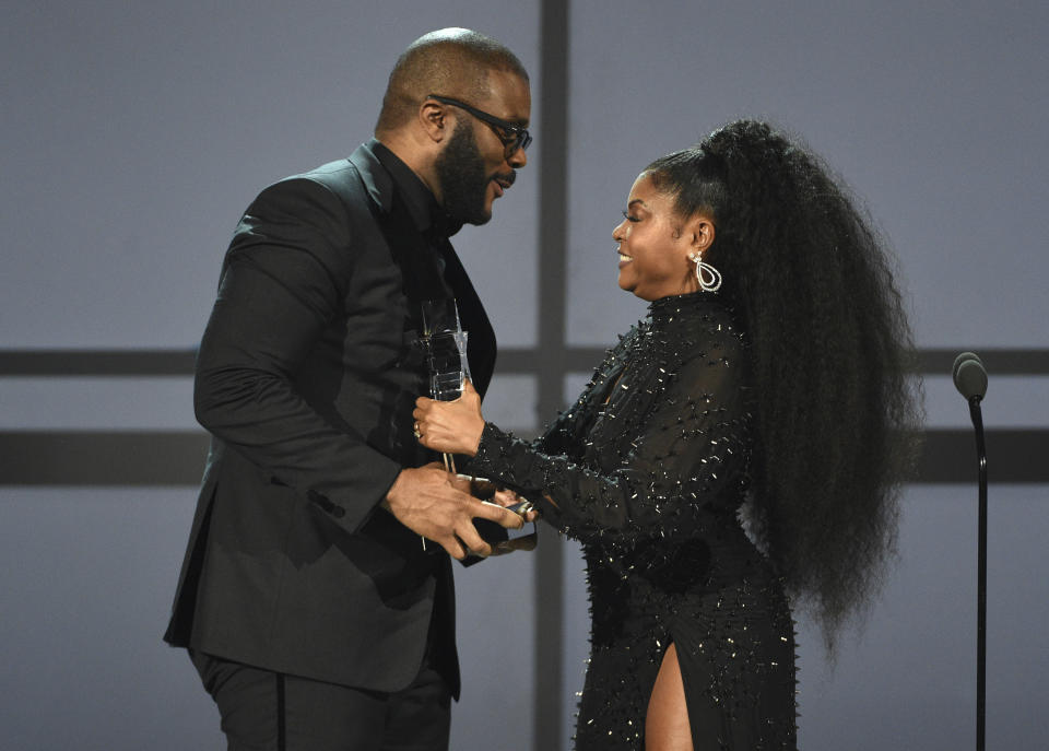 Tyler Perry, left, accepts the ultimate icon award from presenter Taraji P. Henson at the BET Awards on Sunday, June 23, 2019, at the Microsoft Theater in Los Angeles. (Photo by Chris Pizzello/Invision/AP)