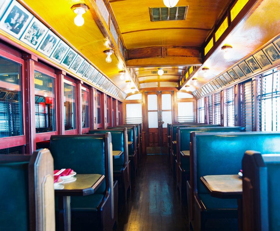 A photo of blue booths in a train car.