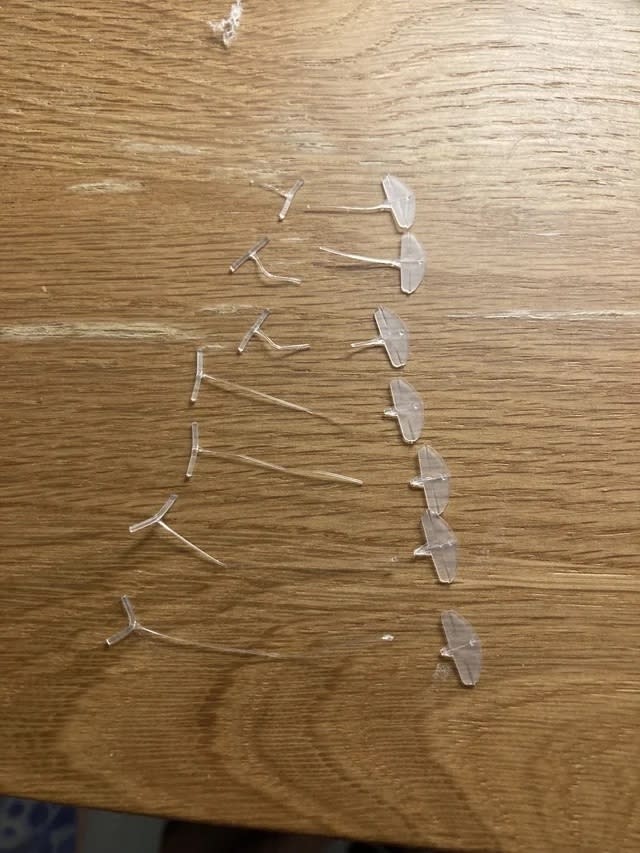 plastic tags from a pack of socks arranged in a line on a wooden surface