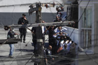 <p>People being evacuated hold their hands above their heads for police in the area of a shooting incident at a United Parcel Service (UPS) facility in San Francisco, California, June 14, 2017. (Stephen Lam/Reuters) </p>