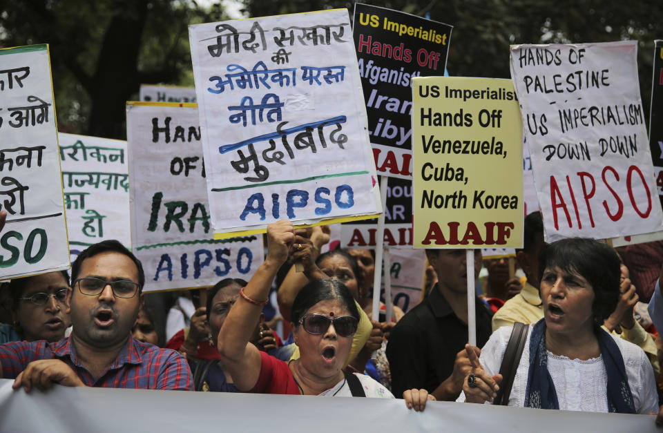 Activists of various left-wing organizations denounce American policies in the Middle East while protesting against the upcoming visit of U.S. Secretary of State Mike Pompeo to India, in New Delhi, India, Tuesday, June 25, 2019. Pompeo is scheduled to travel to India after having visited Saudi Arabia and the United Arab Emirates, on a trip aimed at building a global coalition to counter Iran. Placard in center reads "Down with Modi government's pro-U.S. policies." (AP Photo/Altaf Qadri)