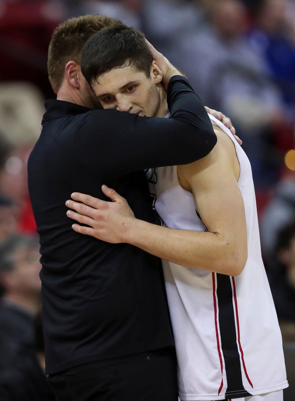 Pewaukee's Nick Janowski hugs head coach David Burkemper as he checks out of the Division 2 championship game against Wisconsin Lutheran for the final time.