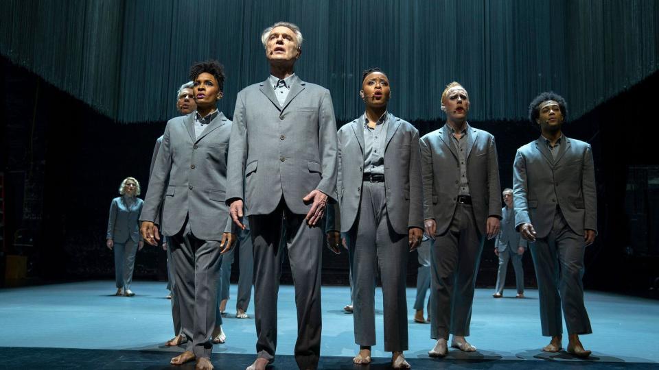 david byrne and the company of american utopia singing wearing grey suits