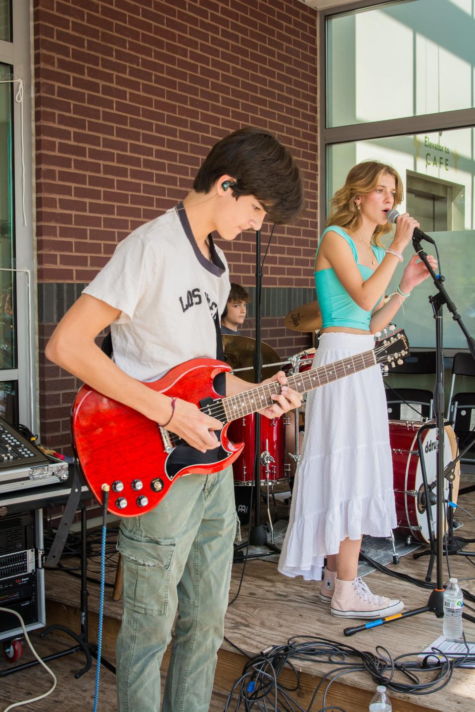 Pop rock band COMPASS performs at Porchrokr in Akron this past summer. From left are Harrison and Arianna Kefalas. The siblings and their brother, Johnny, will compete in the 27th annual Tri-C High School Rock Off in Cleveland.