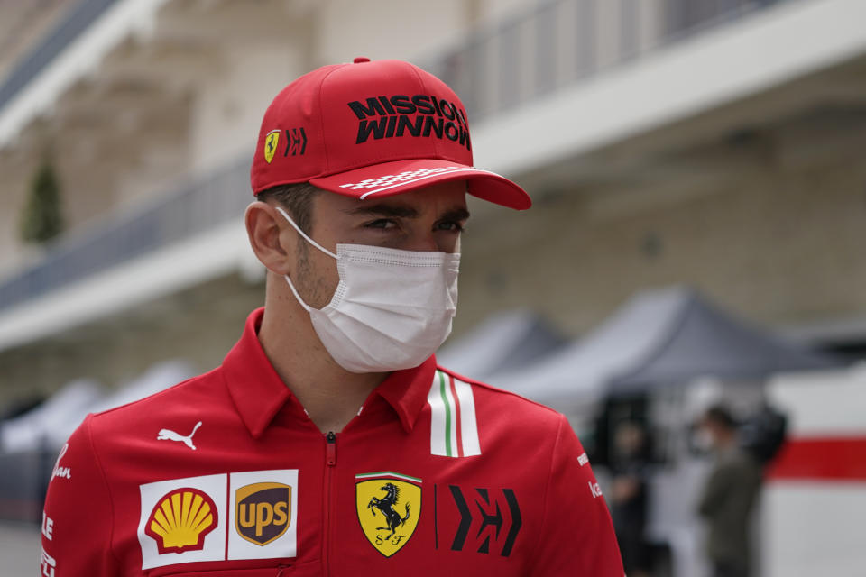 Ferrari driver Charles Leclerc, of Monaco, walks to a news conference before the Formula One U.S. Grand Prix auto race at the Circuit of the Americas, Thursday, Oct. 21, 2021, in Austin, Texas. (AP Photo/Darron Cummings)