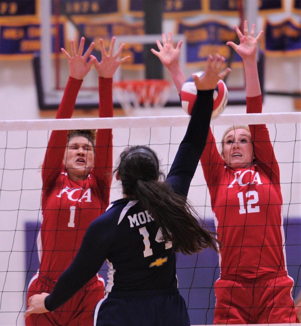 The Red Team's Alexis Garcia (1) of Cooper and Mary Kyle Johnson (12) of Sonora defend against the Blue Team's Jayci Morton of Stephenville. The Red Team beat the Blue 24-26, 25-19, 25-17 at the annual Big Country FCA All-Star volleyball match Saturday, June 7, 2019, at Wylie's Bulldog Gym.