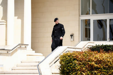 A police officer stands at the entrance to Whitehall Mansions, which houses the Maltese-registered Pilatus Bank, in Ta' Xbiex, Malta March 21, 2018. REUTERS/Darrin Zammit Lupi