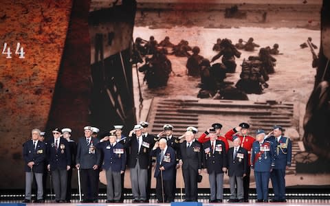 D-Day veterans, front row, stand on stage - Credit: AP