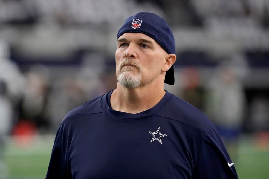 FILE – Dallas Cowboys defensive coordinator Dan Quinn watches players warm up for an NFL football game against the Washington Commanders on Nov. 23, 2023, in Arlington, Texas. Quinn was the 12th candidate to interview for the Los Angeles Chargers head coach opening. Quinn just completed his third season with the Cowboys. He was the Falcons head coach for five-plus seasons (2015-20), where he went 43-42 with a Super Bowl berth after the 2016 season. (AP Photo/Sam Hodde, File)