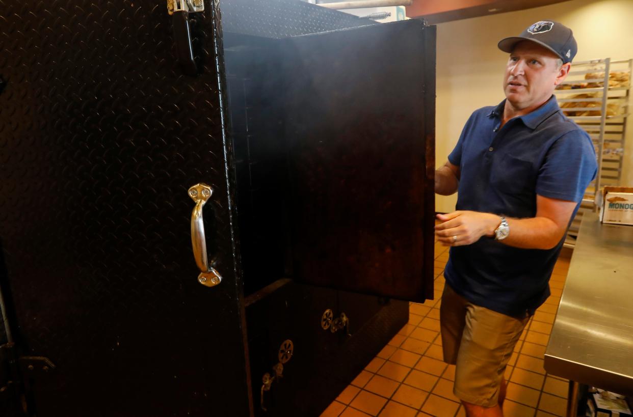 Michael Felts takes a look inside the smoker at Bourbon & Beale on Wednesday, July 15, 2020.