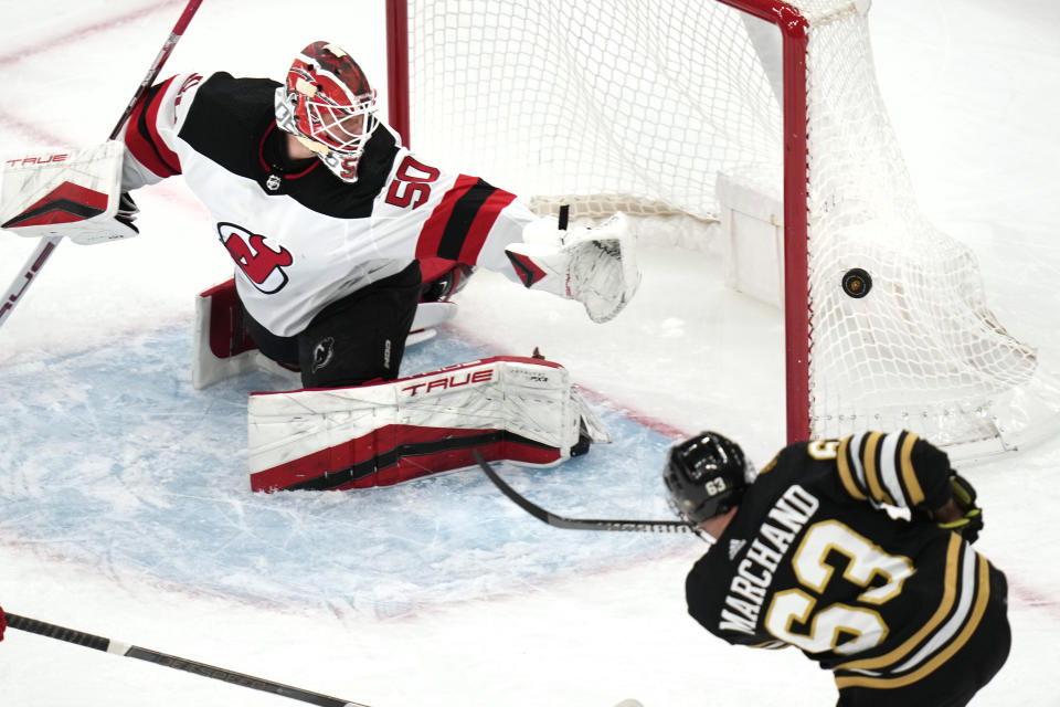 Boston Bruins left wing Brad Marchand (63) shoots wide against New Jersey Devils goaltender Nico Daws (50) during the first period of an NHL hockey game, Monday, Jan. 15, 2024, in Boston. (AP Photo/Charles Krupa)