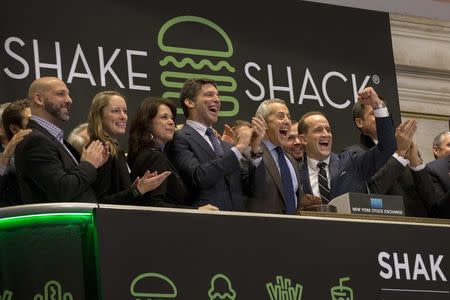 Shake Shack founder Danny Meyer (3rd R) and Shake Shack CEO Randy Garutti (2nd R) ring the opening bell at the New York Stock Exchange to celebrate their company's IPO January 30, 2015. REUTERS/Brendan McDermid