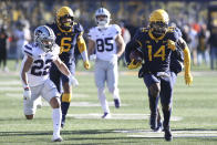 West Virginia safety Malachi Ruffin (14) intercepts the ball during the first half of an NCAA college football game against Kansas State in Morgantown, W.Va., Saturday, Nov. 19, 2022. (AP Photo/Kathleen Batten)