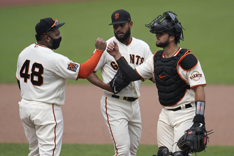 San Francisco Giants' Pablo Sandoval (48) celebrates with Jarlin Garcia, center, and Joey Bart after the Giants defeated the Arizona Diamondbacks in a baseball game in San Francisco, Sunday, Aug. 23, 2020. (AP Photo/Jeff Chiu)