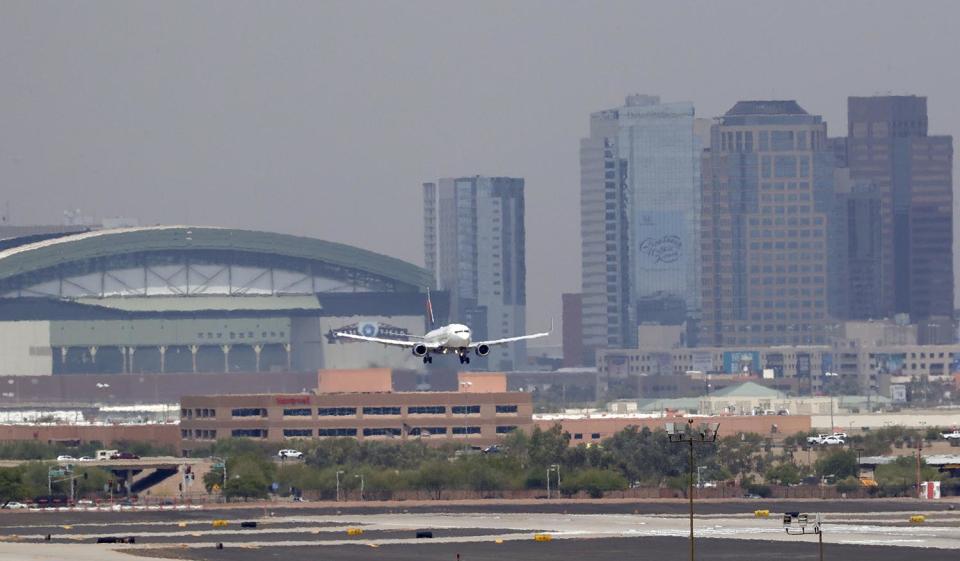 <p>Heat waves ripple across the tarmac at Sky Harbor International Airport as downtown Phoenix stands in the background as an airplane lands, June 20, 2017 in Phoenix. Phoenix hit a high of 118 on Monday with an excessive heat warning in place until Saturday. (Matt York/AP) </p>