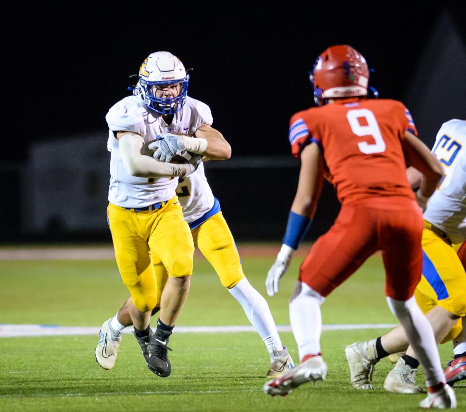 Germantown running back Cooper Catalano carries the ball against Slinger in a WIAA Division 2 first-round playoff game Friday, October 21, 2022, at Slinger High School in Slinger, Wisconsin.