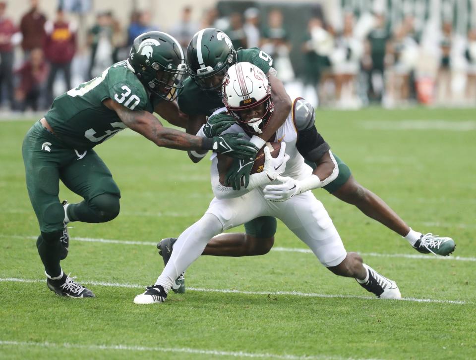 Michigan State cornerback Justin White (30) and cornerback Ronald Williams tackle Minnesota wide receiver Le'Meke Brockington during the first half on Saturday, Sept. 24, 2022, in East Lansing.