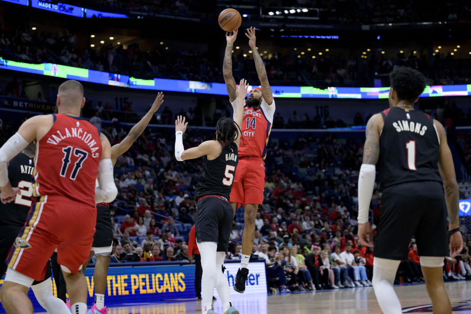 New Orleans Pelicans forward Brandon Ingram (14) shoots against Portland Trail Blazers guard Dalano Banton (5) during the first half of an NBA basketball game in New Orleans, Saturday, March 16, 2024. (AP Photo/Matthew Hinton)