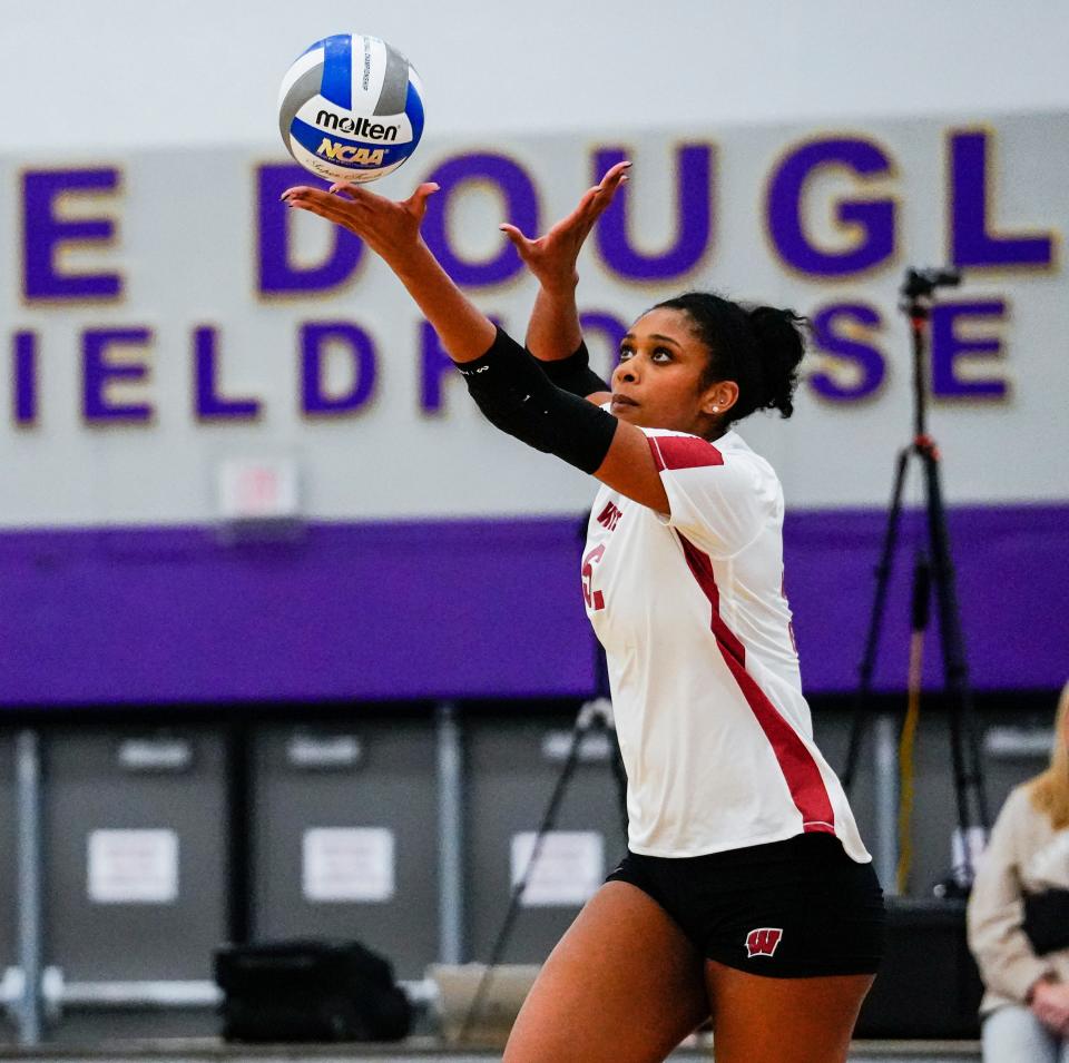 Wisconsin middle blocker Carter Booth serves the ball during the first set of a scrimmage with Marquette on Friday at Oconomowoc High School.