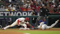 Kansas City Royals' Bobby Witt Jr., right, is tagged out by Los Angeles Angels third baseman Niko Goodrum, left, as he tries to steal third while third base umpire Mark Ripperger watches during the sixth inning of a baseball game Saturday, May 11, 2024, in Anaheim, Calif. (AP Photo/Mark J. Terrill)