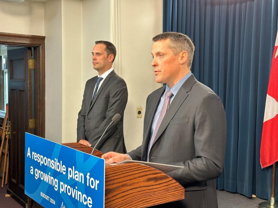 Alberta Finance Minister Nate Horner, right, and Jobs, Economy and Trade Minister Matt Jones explain proposed legislative changes that would allow the expansion of the film and television tax credit and create an tax incentive for skilled tradespeople. (David Bajer/CBC - image credit)