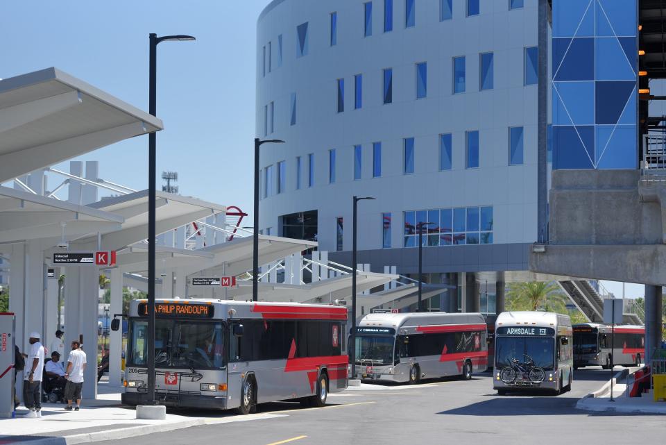 Buses make their way under the elevated Skyway track and under the new JTA headquarters on opening day in May 2020.