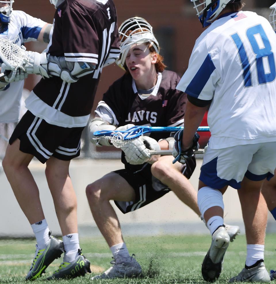 Davis’ Ashton Wood (7) has his helmet knocked off against Fremont in the6A boys lacrosse state semifinal in Salt Lake City on Wednesday, May 24, 2023. Fremont won in the second overtime. | Jeffrey D. Allred, Deseret News