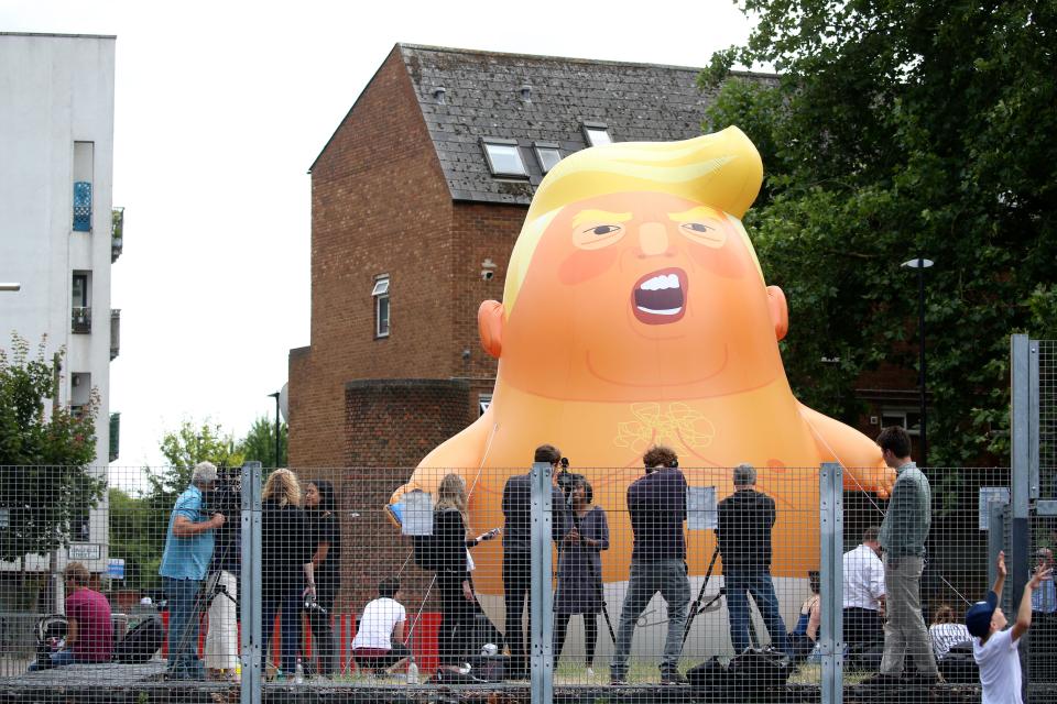 A giant balloon depicting President Trump as an orange baby is inflated by protesters in advance of his visit to the U.K. (Photo: Getty Images).