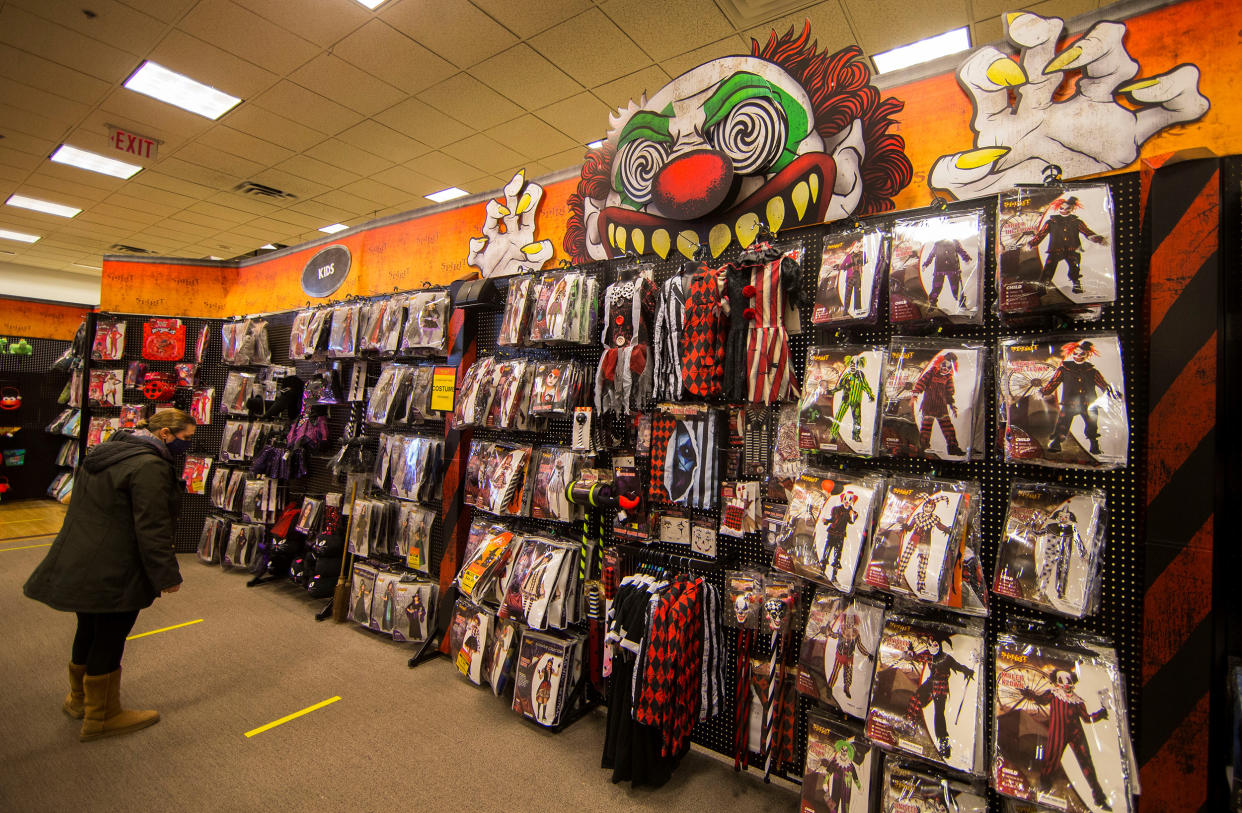 A woman wearing a face mask looks at Halloween decorations and costumes at a store in Mississauga, Ontario, Canada, on Oct. 29, 2020.  (Xinhua News Agency via Getty Images)