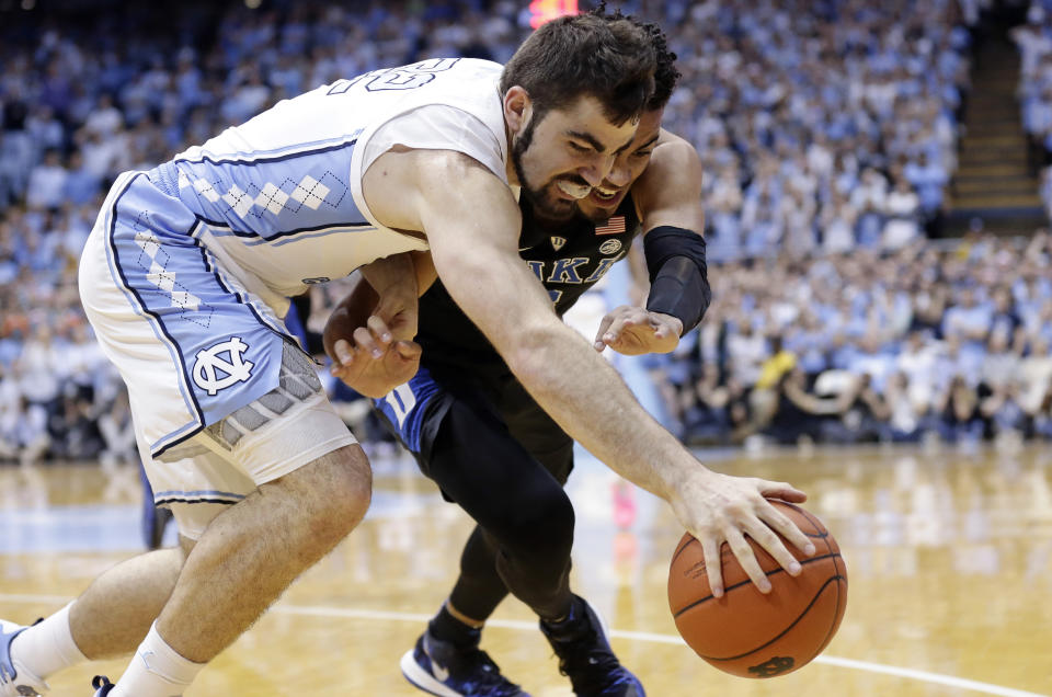 North Carolina's Luke Maye, left, and Duke's Tre Jones battle for the ball during the first half of an NCAA college basketball game in Chapel Hill, N.C., Saturday, March 9, 2019. (AP Photo/Gerry Broome)