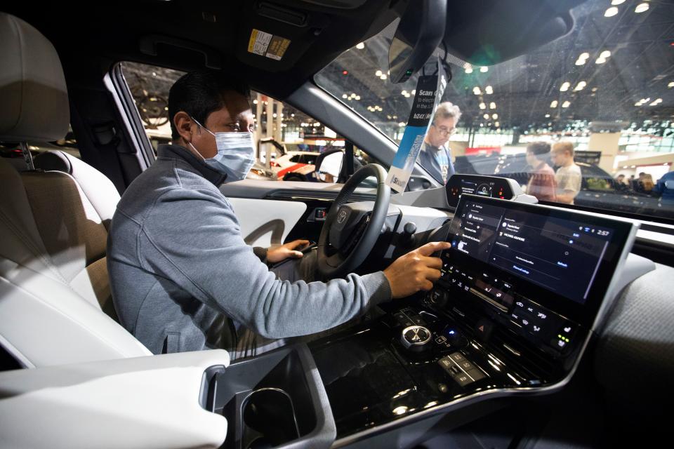 Visitors look at an all-electric car of Toyota at the New York International Auto Show in New York, the United States, April 15, 2022. The New York International Auto Show NYIAS staged a comeback and opened to the general public on Friday after two years of interruption amid the COVID-19 pandemic.   The NYIAS, which dates back to 1900, scales down the exhibition area in 2022 but highlights new electric vehicles EVs from at home and abroad. (Photo by Wang Ying/Xinhua via Getty Images)