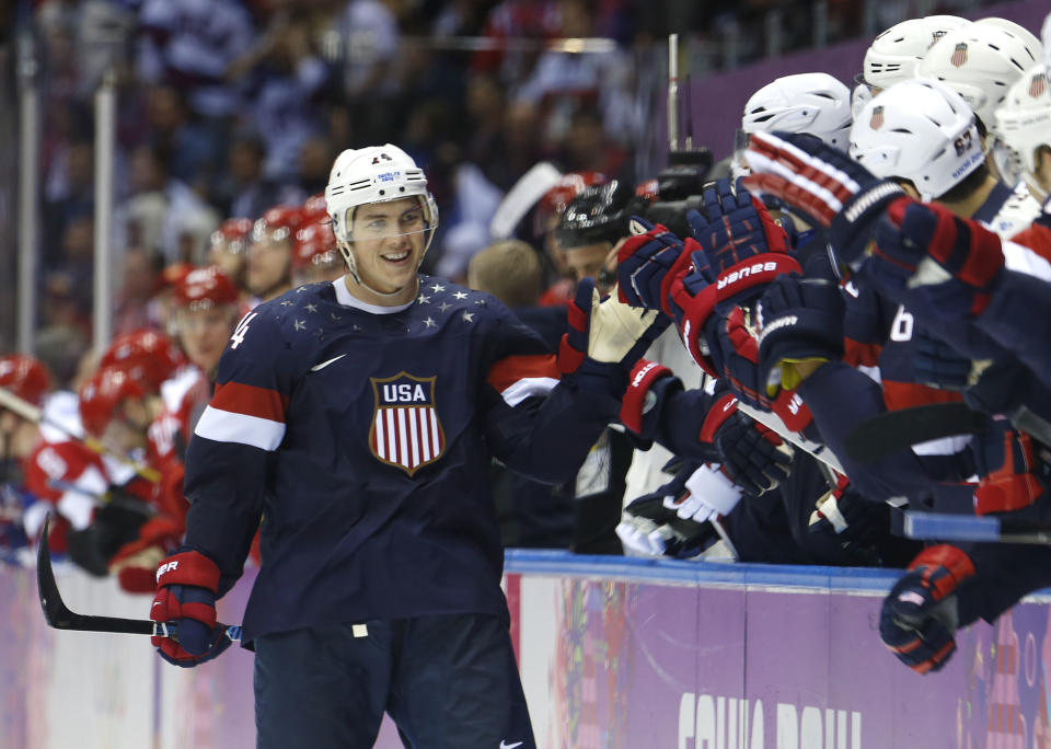 USA forward T.J. Oshie is greeted by treammates after scoring a goal during a shootout against Russia in overtime of a men's ice hockey game at the 2014 Winter Olympics, Saturday, Feb. 15, 2014, in Sochi, Russia. (AP Photo/Mark Humphrey)