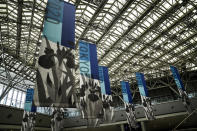 Tokyo 2020 banners adorn the main press center of the 2020 Summer Olympics, Monday, July 12, 2021, in Tokyo. (AP Photo/Jae C. Hong)