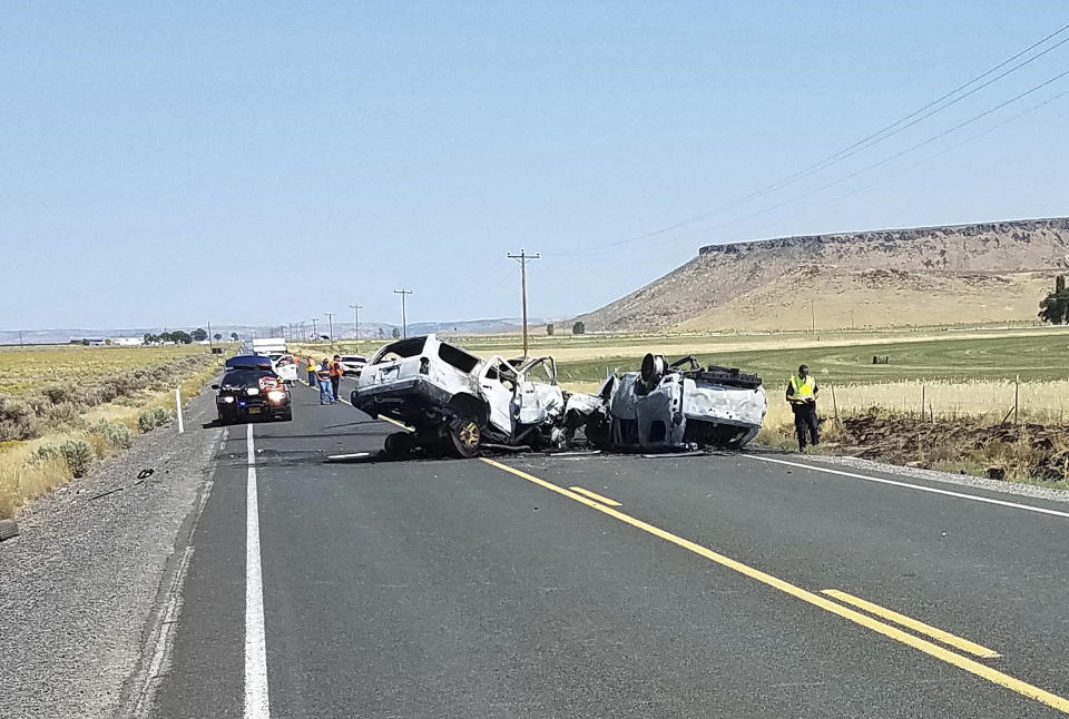 This Monday, Aug. 13, 2018 photo provided by the Oregon State Police shows the scene of a fatal car crash outside Burns, Ore. The collision in rural Oregon that killed eight people happened when the driver of one SUV crossed the centerline and crashed into another SUV carrying seven people. All the victims died at the scene. (Oregon State Police via AP)