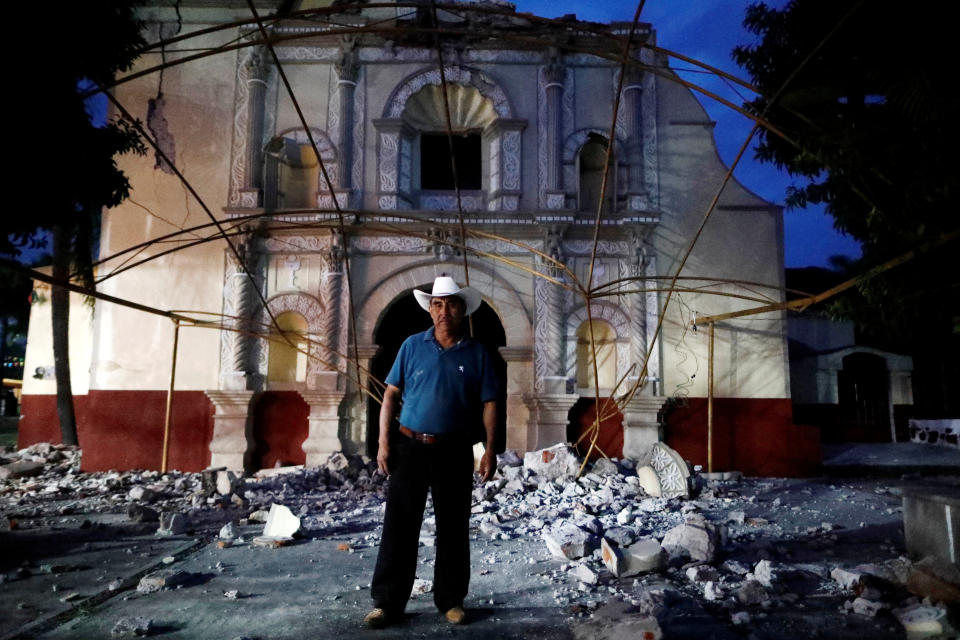 <p>Juan Sanchez, 53, a parishioner and a church guard, poses for a portrait in front San Juan Bautista church after an earthquake in San Juan Pilcaya, at the epicentre zone, Mexico, September 28, 2017. His house wasn’t damaged so he has offered shelter to some families in his backyard. “We are holding mass under a tent. It is a great sadness, we are waiting for the government’s help to rebuild our church,” Sanchez said. (Photo: Edgard Garrido/Reuters) </p>