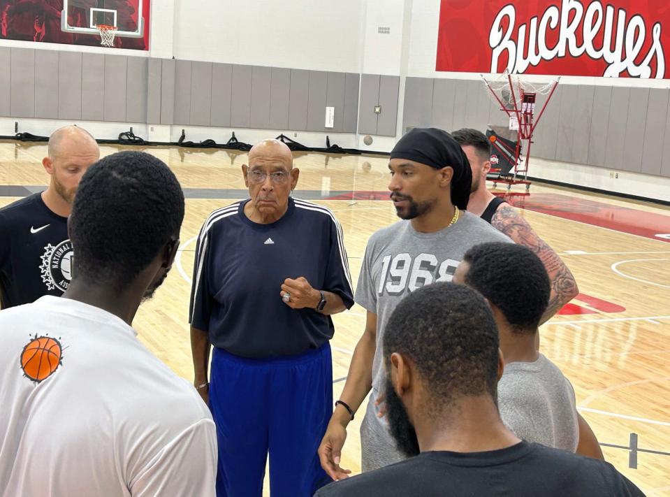 Carmen's Crew coach Jared Sullinger, in a gray T-shirt, talks to the team as his father and assistant coach, Satch, stands to his right and listens during a July 20, 2023 practice at the Jerome Schottenstein Center.