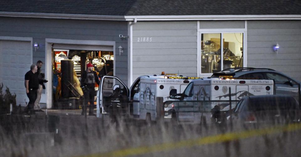 FILE - Investigators from the El Paso County Sheriff's Department and officers from the Humane Society of the Pikes Peak Region investigate a house north of Peyton, Colo., Dec. 7, 2023. On Tuesday, Dec. 12, Colorado authorities released the identities of four people, including three family members, who were found dead inside the home in rural Colorado following a reported shooting the week before. (Jerilee Bennett/The Gazette via AP, File)