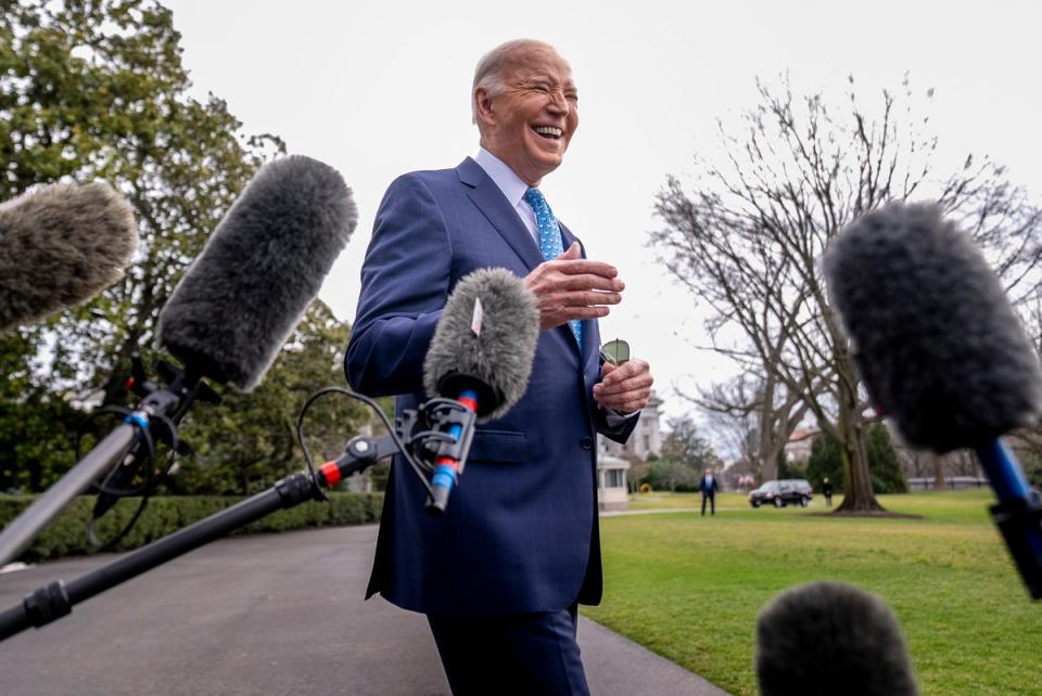 Joe Biden speaks to reporters before leaving the White House on 30 January. (AP)