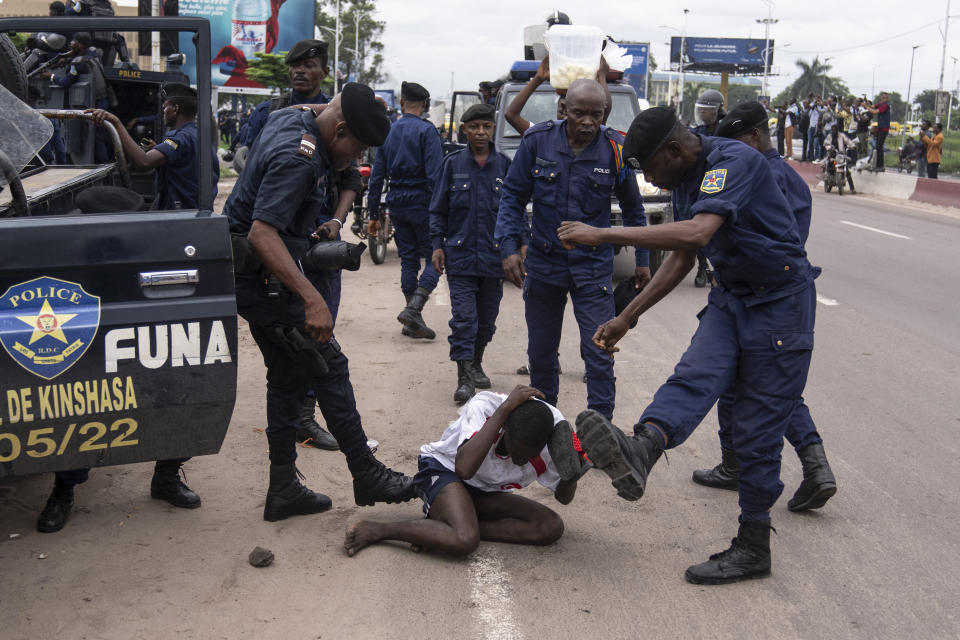 Security forces assault a supporter of presidential candidate Martin Fayulu during clashes outside his party's headquarters, in Kinshasa, Democratic Republic of the Congo, Wednesday, Dec. 27, 2023. Fayulu, a main opposition candidate accused police of using live bullets to break up a protest Wednesday in Congo's capital, as demonstrators demanded a re-do for last week's presidential election. Fayulu is one of five opposition candidates who say the election should be rerun and question its credibility. Some rights groups and international observers also have questioned the vote. (AP Photo/Mosa'ab Elshamy)