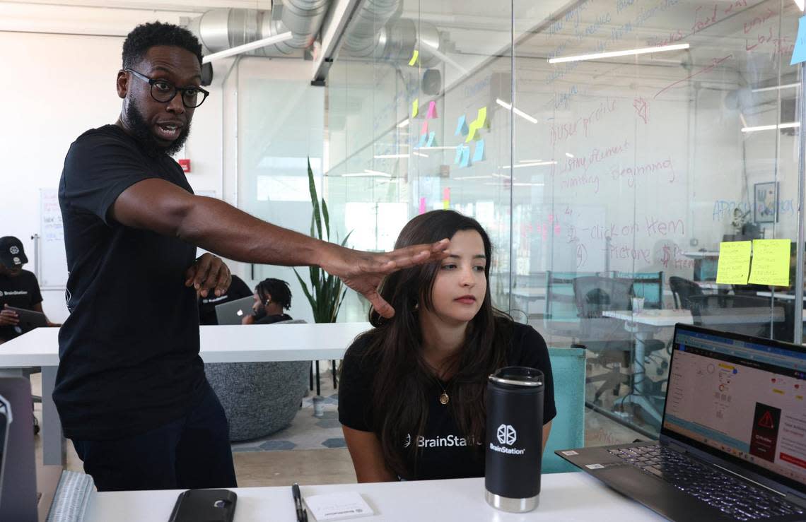 Christopher Bartley, class instructor, left, helps a group with a project during a breakout session in class at Brainstation in Wynwood on March 8, 2023.