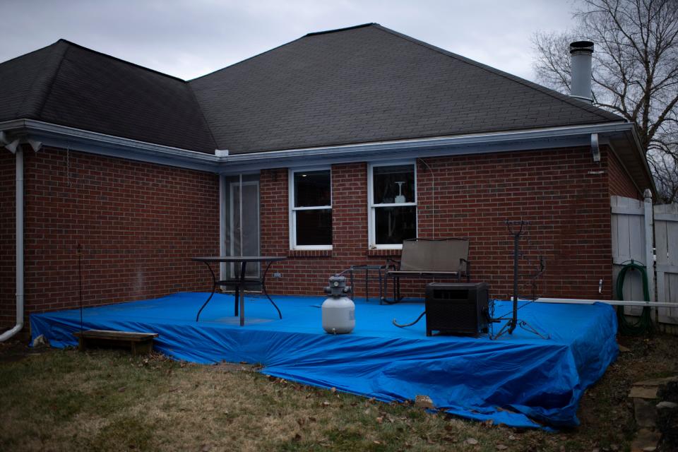 The deck of what was supposed to be a sunroom at Dennis and Melanie Szorcsik's Newburgh, Ind., home is covered in a dry-rotted tarp which has allowed water to damage the wood beneath Wednesday afternoon, Feb. 16, 2022. The contractor hired to do the job, Matthew S. Gates, CEO of Elite Construction Systems in Evansville, has been charged with felony home improvement fraud in Warrick County.